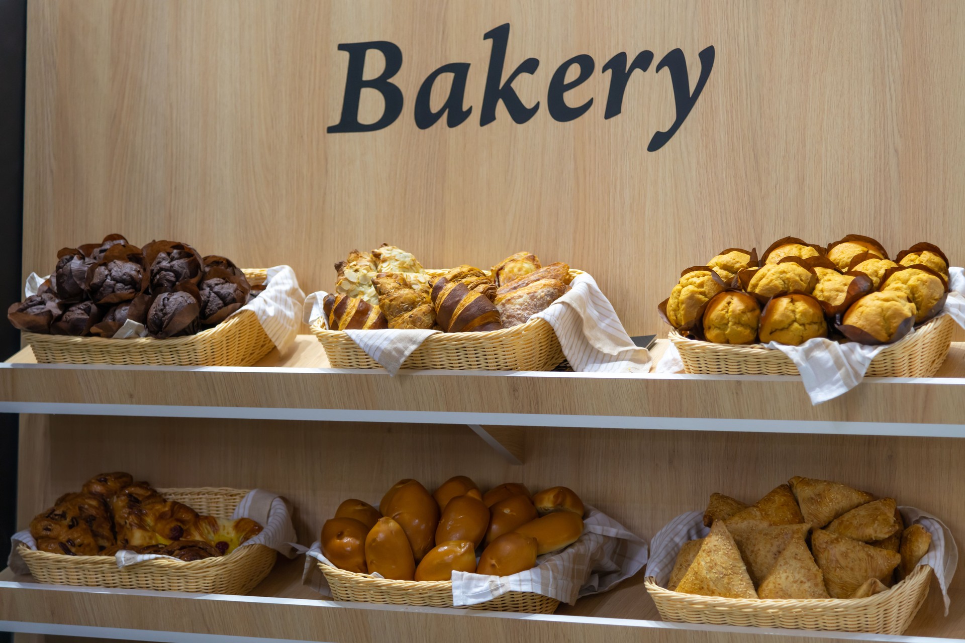Delicious baked goods displayed in a bakery setting with warm lighting